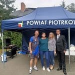 Grupa 4 osób pred namiotem z napisem powiat piotrkowski